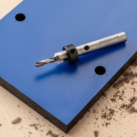 Drill bit on phenolic board for Phenolic Zero Clearance Table Saw Insert Blanks 2 Pack For Reduced Splintering And Ultra Smooth Cuts