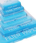 Stack of blue boxes labeled 'Filter Paper' containing Pro Grade Qualitative Filter Paper 12.5 Cm Diameter Medium Speed 85 GSM 10 Micron Pore Size Pack Of 100 For Lab Filtration Great For Chemistry And Bio Experiments Reliable Quality For Qualitative Analysis standing over white background