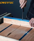 Close-up of hands securing 36 Inch Universal T Track With Double Cut Profile And Pre Drilled Mount Points for use on a table saw.