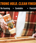 Man applying Heavy Duty Wood Glue For Indoor And Outdoor DIY Projects, Water Resistant 36 Ounce Bottle to wooden surface.