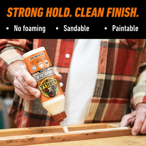 Man applying Heavy Duty Wood Glue For Indoor And Outdoor DIY Projects, Water Resistant 36 Ounce Bottle to wooden surface.