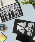 Flexible Magnetic Sheets For Die Storage 5 By 7 Inch 35 Pack Non Adhesive Die Cut Magnet Sheets For Crafts DIY Projects Photo Organization And Scrapbooking displayed with tree die cuts on a desk.