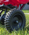 Close-up of durable rugged poly tires on Beefy Workhorse Walk Behind Broadcast Spreader For Grass Fertilizer And Seeds With 65 Pound Hopper