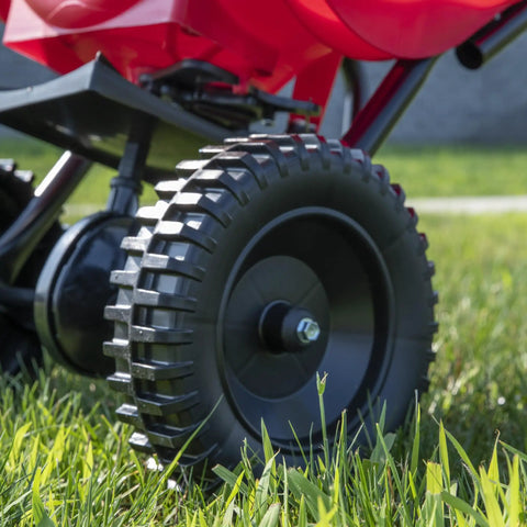 Close-up of durable rugged poly tires on Beefy Workhorse Walk Behind Broadcast Spreader For Grass Fertilizer And Seeds With 65 Pound Hopper