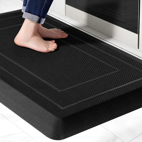 Person standing on Extra Thick Anti Fatigue Kitchen Mat 0.9 Inch Cushioned Standing Desk Mat with Waterproof High Density Foam Non Slip Ergonomic Comfort Mat for Kitchen Office Workstation 20 by 32 Inches Black