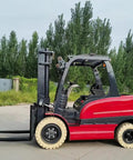 Portable Electric Forklift 4Way Mini Lift Truck With Adjustable Reinforced Forks Solid Tires Ergonomic Seat side view outdoors