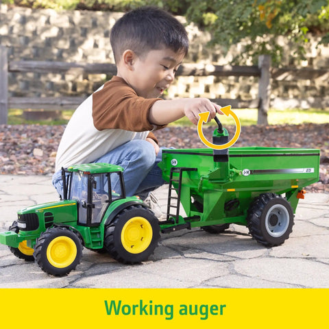 Child playing with One Sixteenth Scale Big Farm 7430 Tractor With Grain Cart Toy Set Featuring Lights And Sounds For Kids