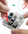 Removing keycaps from Nine Key Cherry MX Switch Tester For Mechanical Keyboards with a clear crystal acrylic base and keycap puller.