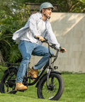 Rider on fat tire electric bike for adults with 28 MPH top speed, 48V power, and 80 mile range, featuring 20 inch fat tires, in black