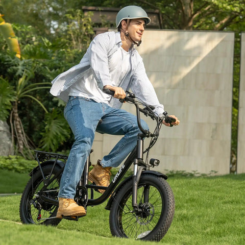 Rider on fat tire electric bike for adults with 28 MPH top speed, 48V power, and 80 mile range, featuring 20 inch fat tires, in black
