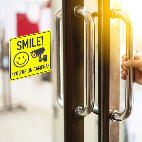 Smile Youre On Camera Signs 7 By 7 Inch 8 Pack Security Notice Stickers For Home Office And Outdoors Deterrent Alerts Visitors Theyre On Camera And Helps Keep Your Family And Property Safe With This Easy To Install Sign Set. yellow vinyl camera warning sign on glass door