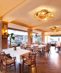 Restaurant interior with Caged Low Profile Ceiling Fan With Light 20 Inch Flush Mount Boho Hemp Rope Farmhouse Style Six Gear Wind Speeds.