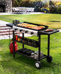 Four Burner Portable Propane Griddle With Electronic Ignition 40,000 BTU Flat Top Gas Grill Rolling Cart in garden setting