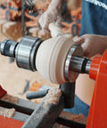 BMWOOD woodturning tailstock chuck adapter mounted on a lathe turning a light wood blank.