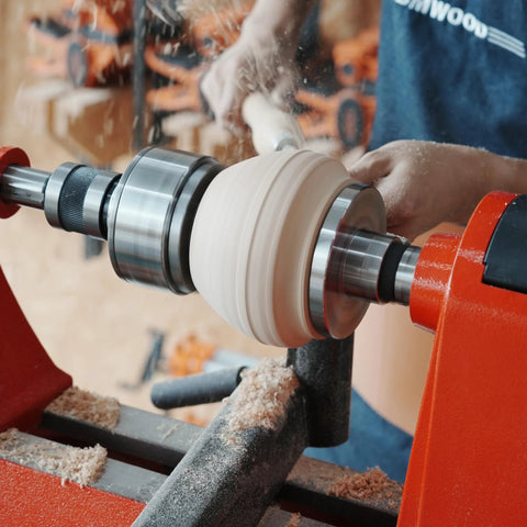BMWOOD woodturning tailstock chuck adapter mounted on a lathe turning a light wood blank.