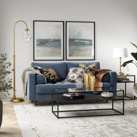 70 Inch Tall Arc Floor Lamp With Teardrop Seeded Glass Shade In Brass Finish beside blue sofa in living room