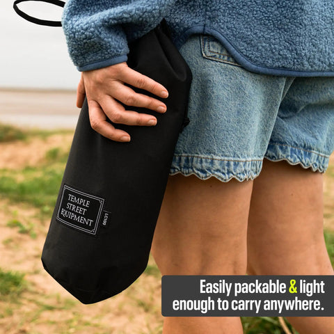 Person holding Ultra Lightweight Compact Camping Chair With Low Back Minimalist Design Folds Into Small Carry Bag