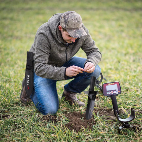 Man using Heavy Duty Serrated Edge Metal Detecting Shovel With Belt Loop Sheath in field with metal detector