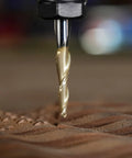 Close-up of SpeTool tapered ball-nose end mill with 1/4 in shank and 1/32 in radius, gold ZrN coating cutting into wood.