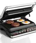 Kick Up Your Dinner Game With This Badass 3-In-1 Electric Grill Indoor with burgers and eggs cooking on ceramic plates.