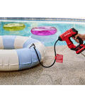 V20 Cordless Tire Inflator And Portable Air Compressor inflating a pool float by a swimming pool.