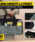 Person holding 13-inch wide mouth bag with tools from 142 Piece Home Tool Kit for repairs, featuring multiple pockets.