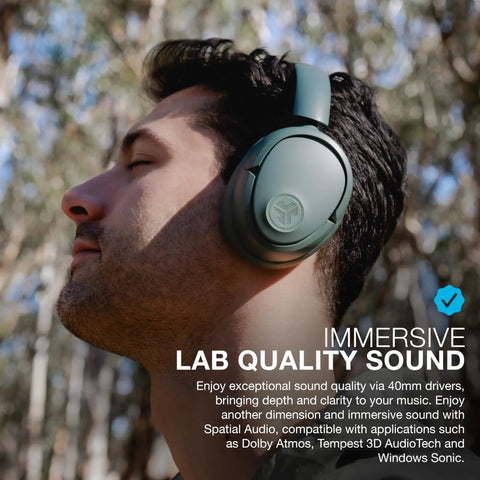 Person wearing JBuds Lux ANC Over Ear Headphones With Wireless Active Noise Cancellation Bluetooth Spatial Audio outdoors