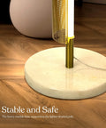 Close-up of the marble base of Callie LED Floor Lamp 55 Inch Tall Industrial Style With Metal Grid Shade for stability.