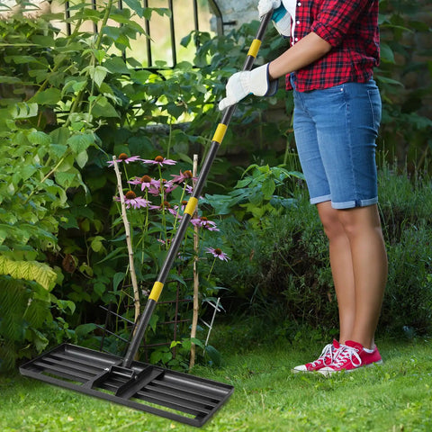 Person holding Heavy Duty Lawn Leveling Rake With 30 Inch Blade And Adjustable Handle For Easy Yard Dirt Grading