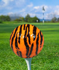 Tiger Print Novelty Golf Balls 12 Pack With Full Wrap Tiger Design Color Balls on golf tee against green field