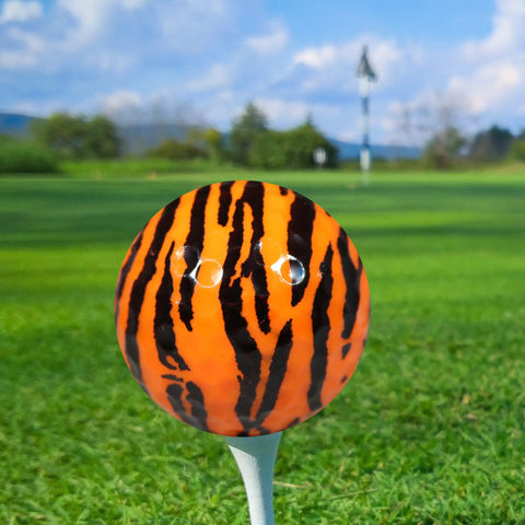 Tiger Print Novelty Golf Balls 12 Pack With Full Wrap Tiger Design Color Balls on golf tee against green field