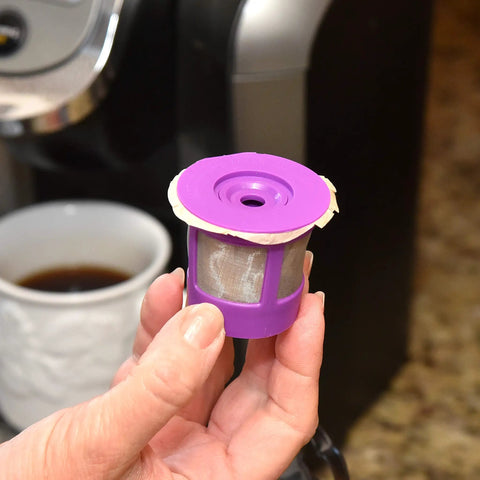 Straight Up Heavy Duty Unbleached Paper Filters With Lid For Reusable K Cups 700 Count Box in hand near coffee maker.