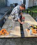 Man using Five Sixteenth Inch Thread Cutting Self Drilling Deck Screws Type Seven Star Drive on trailer decking