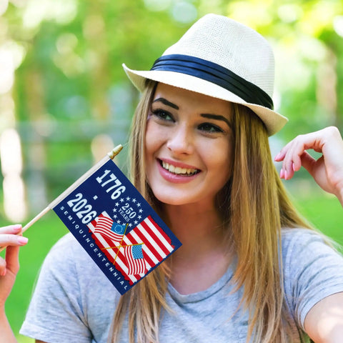 Woman holding 250th Anniversary USA Flags On Sticks 5X8 Inch Mini Handheld Flags 12 Pack Patriotic Flags For 1776 To 2026 Independence Day