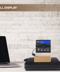 Digital Postal Shipping Scale That Crushes It 110 Lb 50 Kg To 0.1 Oz 2 G Precision With wall mount display in office setting.