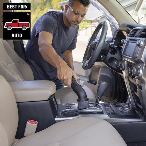 Man using Beast Tough Heavy Duty Wet Dry Vac Attachment Kit For One Seven Eighths Inch Hoses Pro Grade Shop Vacuum in car interior.