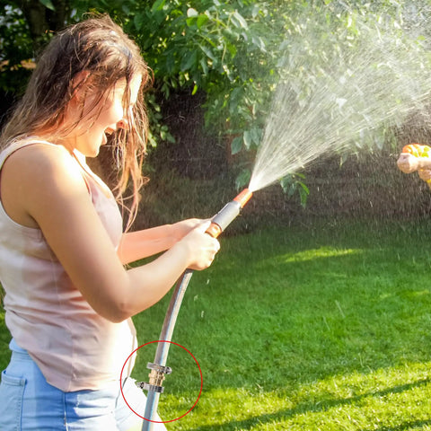 Woman using a garden hose with spray nozzle, highlighting the 4 Pack Garden Hose Repair Kit with Stainless Clamps Fits 3/4 to 5/8 Inch Hoses.