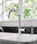 Precept Single-Handle Kitchen Faucet with Side Sprayer in Chrome, 360 Degree Swivel, setup in a modern kitchen with a window view