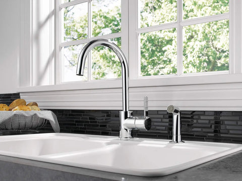 Precept Single-Handle Kitchen Faucet with Side Sprayer in Chrome, 360 Degree Swivel, setup in a modern kitchen with a window view
