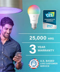 Man smiling at phone under Alexa Compatible Color Changing Smart Bulb with auto pairing and Bluetooth mesh features displayed.