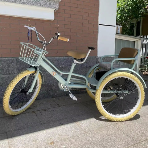 Light green 20-inch outdoor cruiser tricycle with pneumatic tires and tandem back seat on pavement, side view