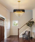Five Light LED Teardrop Crystal Pendant Chandelier In Gold Finish For Kitchen Island Foyer Hallway And Bedroom Modern Raindrop Ceiling Light With 4000K Neutral White Glow Lit, shown in modern living space with staircase.