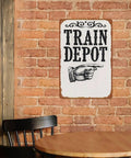 Train Depot Aluminum Wall Decor 12x8 Inch, railroad sign on brick wall in dining area with chair and table