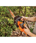 Person trimming bush with 40V MAX Cordless Hedge Trimmer With 24 Inch Dual Action Blade, No Cords Needed, Long Battery Life