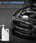 Smooth Shift Fluid Pump For Standard Quart Jugs And Transmission Sump With 4Cc Per Stroke Differential Gear Oil Manual Hand Rig with bendy hose next to a car engine.