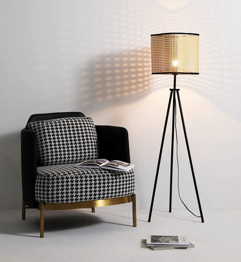 Mid Century Bohemian Tripod Floor Lamp With PVC Rattan Shade and Velvet Rim next to a houndstooth armchair.