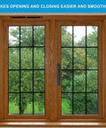 Wooden framed sliding window with black grid pattern, view of green trees outside.