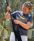 Person handling FXW stakes with Stakes Bag For Camping And Outdoor Use Stow And Carry Dog Pen Stakes With Ease Heavy Duty Travel Case Compatible With All Brand Stakes Keeps Gear Neat In RVs And Campgrounds While You Roll.