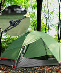 Heavy Duty Tarp Clips With Locking Thumb Screws For Canopies And Tents, shown securing a green camping tent outdoors