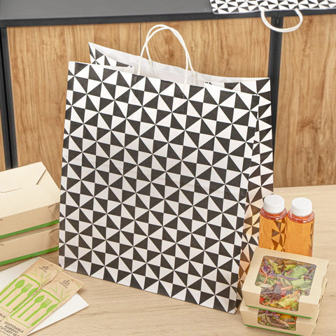 Vogue Tear-Resistant White Gift Bags With Built-In Handles, 100 Count, Paper Retail Bags With Black Print displayed on table